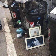 Overflowing garbage bins with litter scattered on the ground around them.